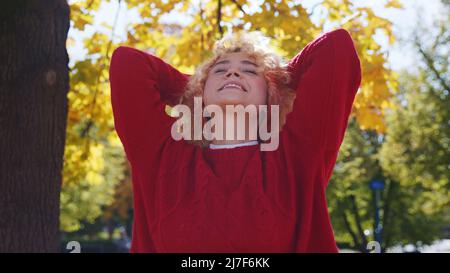 Attractive carefree blond girl enjoys her time in park autumn medium closeup copy space . High quality photo Stock Photo