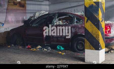 2022.04.24. Warsaw, Poland. one side of a red damaged car in the underground lot. High quality photo Stock Photo