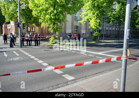 Leipzig, Germany. 09th May, 2022. Police cordon tape is stretched at a street crossing. Environmental activists from the group 'Last Generation' blocked rush hour traffic on Jahnallee this morning. The activists got stuck on the roadway. Police task forces cordoned off the area and removed the demonstrators. In the west, traffic was backed up over a wide area. Credit: Christian Modla/dpa/Alamy Live News Stock Photo