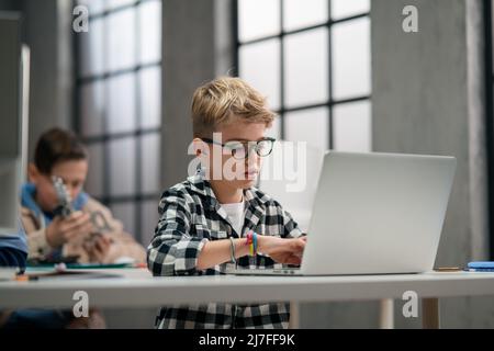School kids using computer in classroom at school Stock Photo