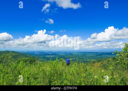 Rear view of a hiker against a mountain background at Mbeya, Tanzania Stock Photo