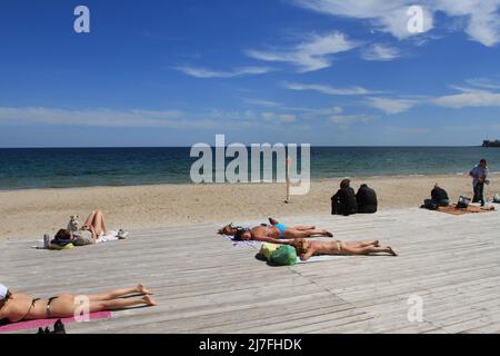 People sunbathing on Dolphin Beach by the Caribbean Sea, Cancun, Mexico