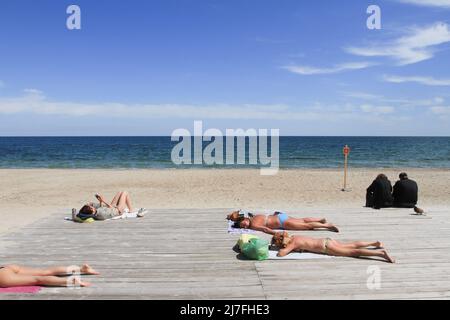 People sunbathing on Dolphin Beach by the Caribbean Sea, Cancun, Mexico
