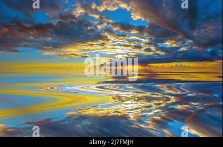 Gathering storm clouds reflected on a smooth body of water Stock Photo