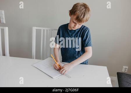 Schoolboy doing homework Stock Photo