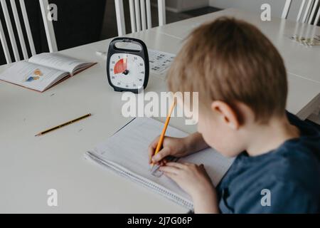 Schoolboy doing homework Stock Photo