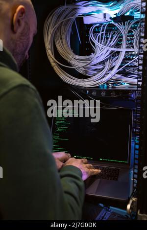 Male programmer working on laptop Stock Photo