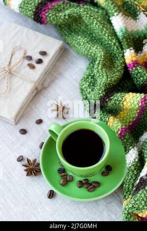 Green cup of coffee with coffee beans and anise star Stock Photo