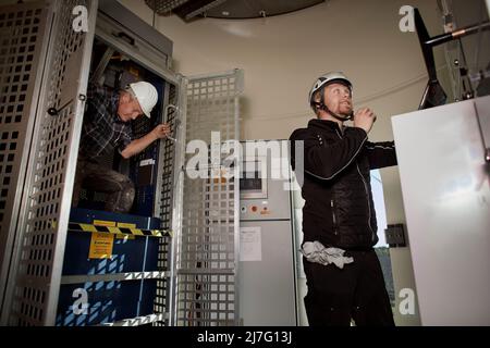 Engineers working in wind turbine Stock Photo