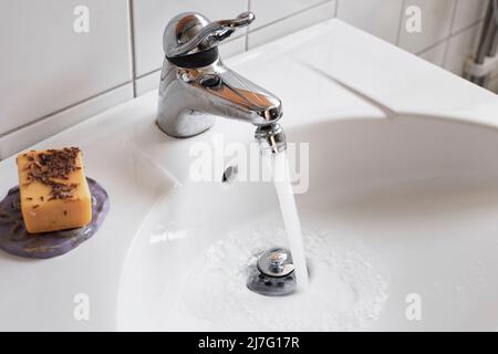 Water running from bathroom tap Stock Photo