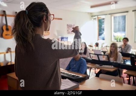 Teenagers attending keyboard lesson Stock Photo