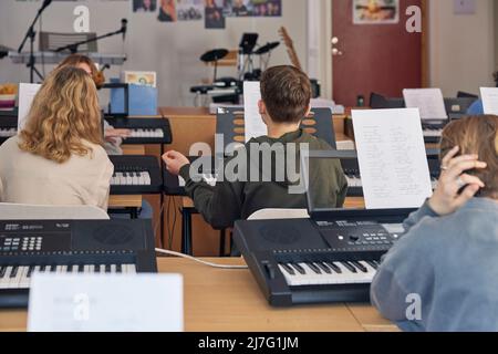 Teenagers attending keyboard lesson Stock Photo