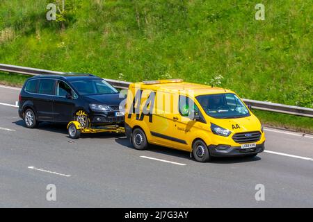 AA Van yellow 24hr recovery truck, Ford Transit Custom 340 Base carrying broken down vehicle. Side view of rescue breakdown recovery vehicle towing 2015 Seat Alhambra SE LUX Ecomo CR Stock Photo