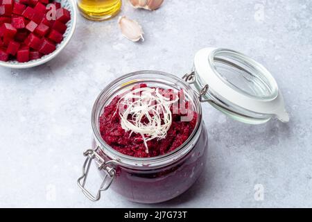 Homemade beet pesto sauce with horseradish in glass jar. Healthy vegetarian detox diet food Stock Photo