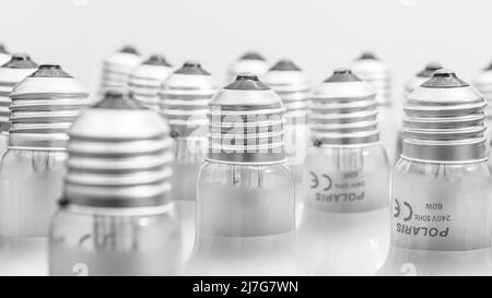 Monochrome close shot of glass incandescent light bulb cap with E27 / Edison Screw fitting. For illuminating, UK lighting industry, lighting abstract. Stock Photo