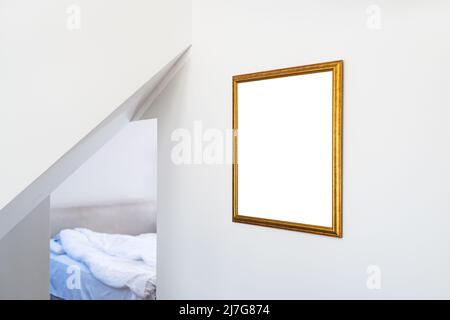 Mockup for painting in golden picture hanging on hotel room wall with copy space Stock Photo