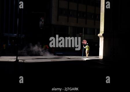 Street worker with stop sign downtown New York City Stock Photo