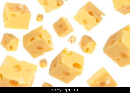Falling cheese cubes, isolated on white background, selective focus. Maasdam cheese Stock Photo