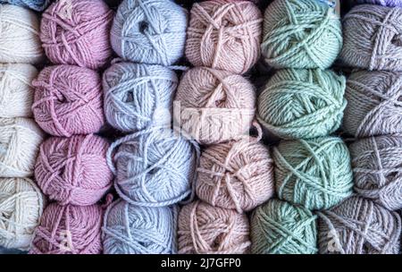 Colorful balls of wool on wooden table. Variety of yarn balls, view from above. Stock Photo