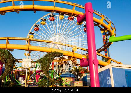 Roller Coaster Big Dipper and Ferris wheel on Santa Monica Pier, Pacific Park amusements. Santa Monica, California, USA Stock Photo