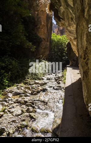 Hiking the Los Cahorros trail through a gorge with a stream near Granada, Spain Stock Photo