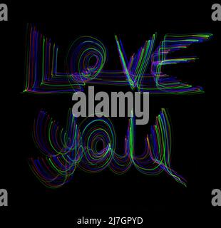 The words 'Love You' written in the air with bright neon coloured motion trails on a black background Stock Photo