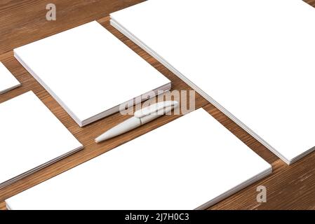 Mockup with various formats of corporate cards and folders on dark wood background with shadows Stock Photo