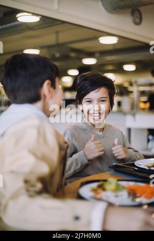 11 years boy showing thumbs up gesture Stock Photo - Alamy