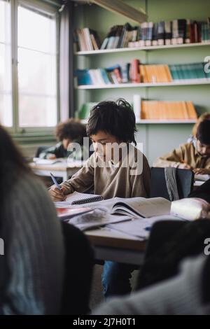 Children sitting in the classroom and studying Stock Photo - Alamy