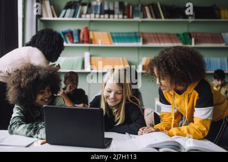 Portrait of diverse students studying together through e-learning in classroom Stock Photo