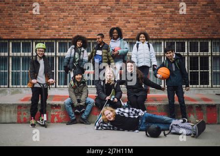Portrait of diverse students enjoying in front of school building Stock Photo