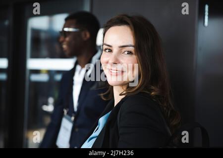 Side view portrait of businesswoman smiling at seminar Stock Photo