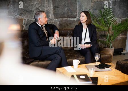 Business professionals talking to each other while sitting on sofa at seminar Stock Photo