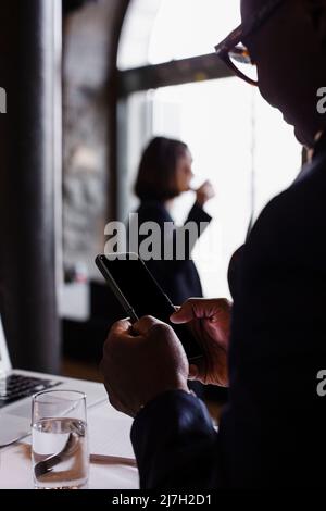 Businessman using mobile phone in conference center Stock Photo
