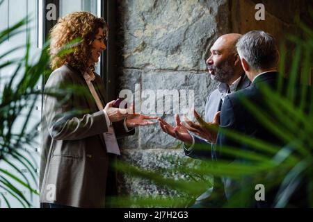 Business professionals gesturing while talking to each other in conference center Stock Photo
