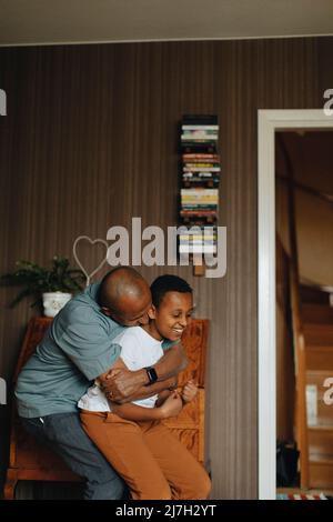 Father and son playing together at home Stock Photo