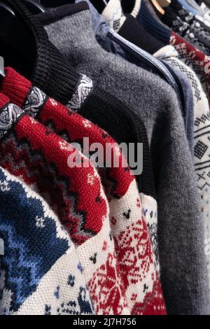 Handmade woolen Scandinavian ladies cardigans, Norwegian style sweater in all kinds of colors and patterns, in an open air market stall Stock Photo