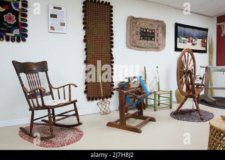 Antique rocking chair and furnishings in room inside old 1790 Maison Rosalie-Cadron House Museum, Lavaltrie, Quebec, Canada. Stock Photo