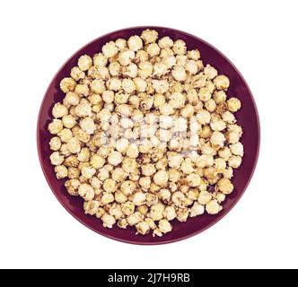 caramel popcorn on dark dish plate Stock Photo