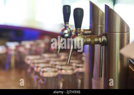 Close up of beer lines for draft beer in restaurant. Silver Cranes for pouring beer or wine in night club, bar or restaurant. Bartender workplace. Stock Photo