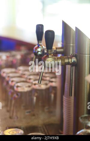 Close up of beer lines for draft beer in restaurant. Silver Cranes for pouring beer or wine in night club, bar or restaurant. Bartender workplace. Stock Photo