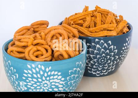 Murruku (aka Chakli) and Khara Khaddi south Indian fried snacks made from rice flour and ghee butter for festivals Diwali, Navratri, Pongal, Deepawali Stock Photo