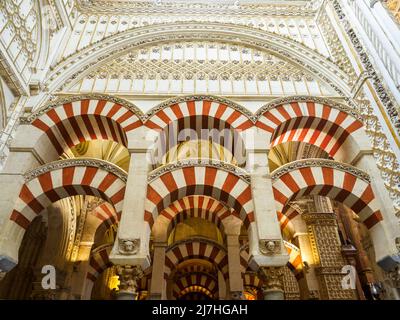 Decorated archways and columns in Moorish style in the  Mezquita-Catedral (Great Mosque of Cordoba) -  Cordoba, Spain Stock Photo