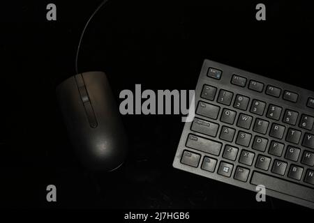Computer mouse and portion of standard size keyboard isolated on black background Stock Photo