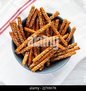 Baked Pretzel Sesame Sticks in a Bowl, top view. Flat lay, overhead, from above. Stock Photo