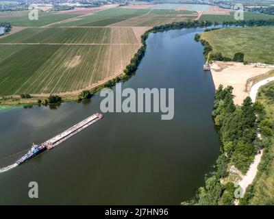 A cargo barge floats on the river Stock Photo