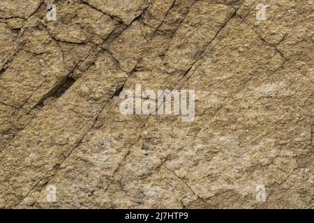 Shale massif texture with quartz inclusions. Surface of slate rock is cut by diagonal cracks, abstract background, high resolution. Stock Photo