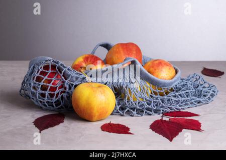 Apples in eco friendly reusable mesh bag made from recycled materials Stock Photo