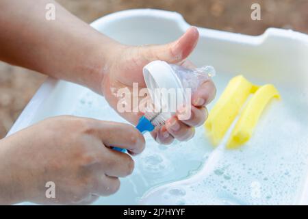 Washing baby nipples. Mother's hand washing the baby nipples Stock Photo -  Alamy