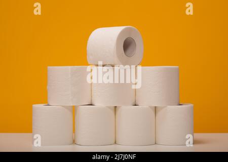 Lots of toilet paper rolls on a yellow background.